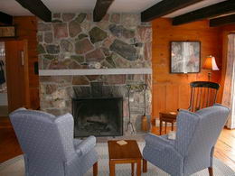 Living Room - The living room fireplace is hand built with samples of copper, silver, granite, calcite and a selection of examples of other exotic minerals collected by the owners. - Country homes for sale and luxury real estate including horse farms and property in the Caledon and King City areas near Toronto